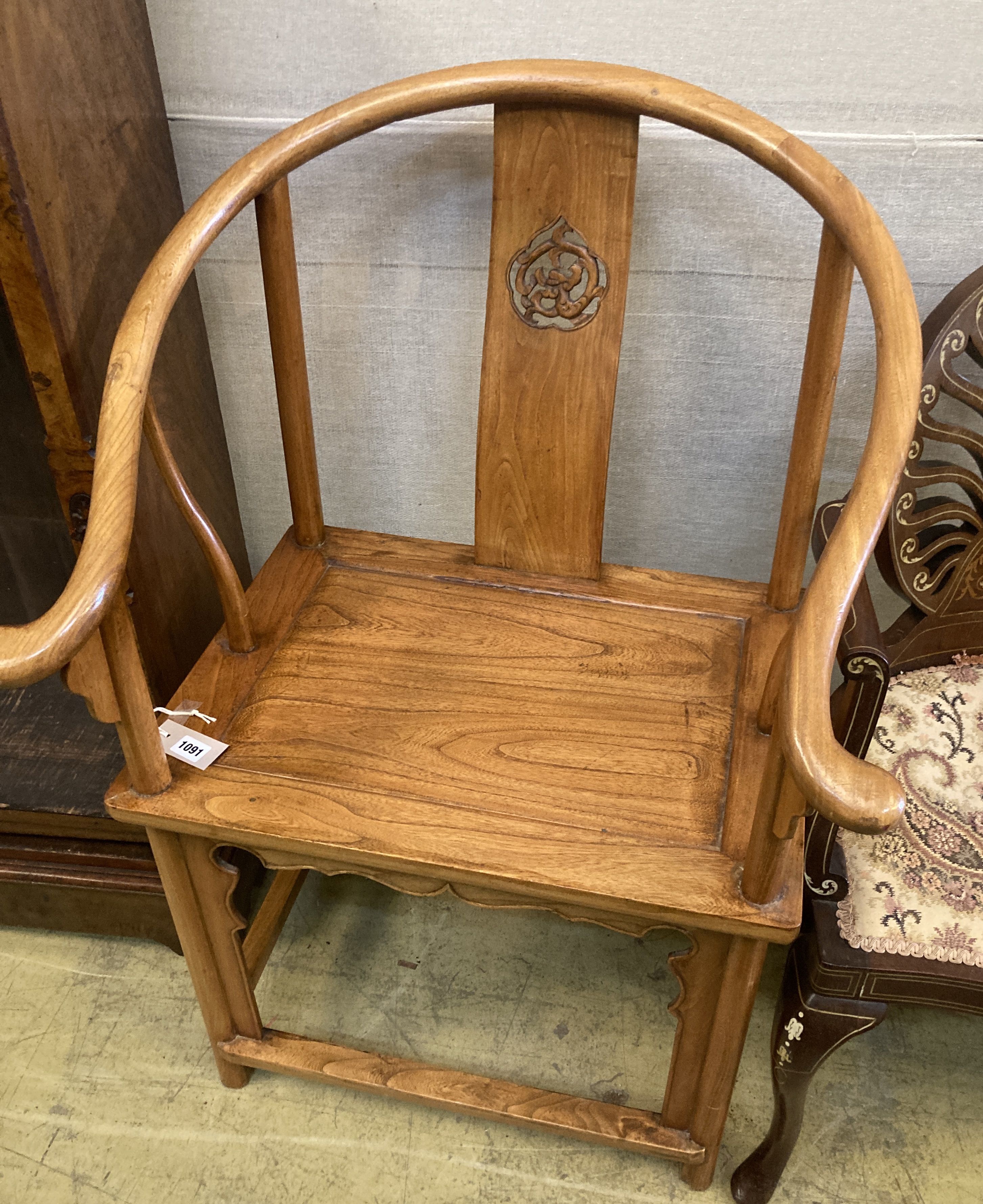 A Chinese elm armchair, with round back and pierced carved splat, width 67cm, depth 50cm, height 100cm